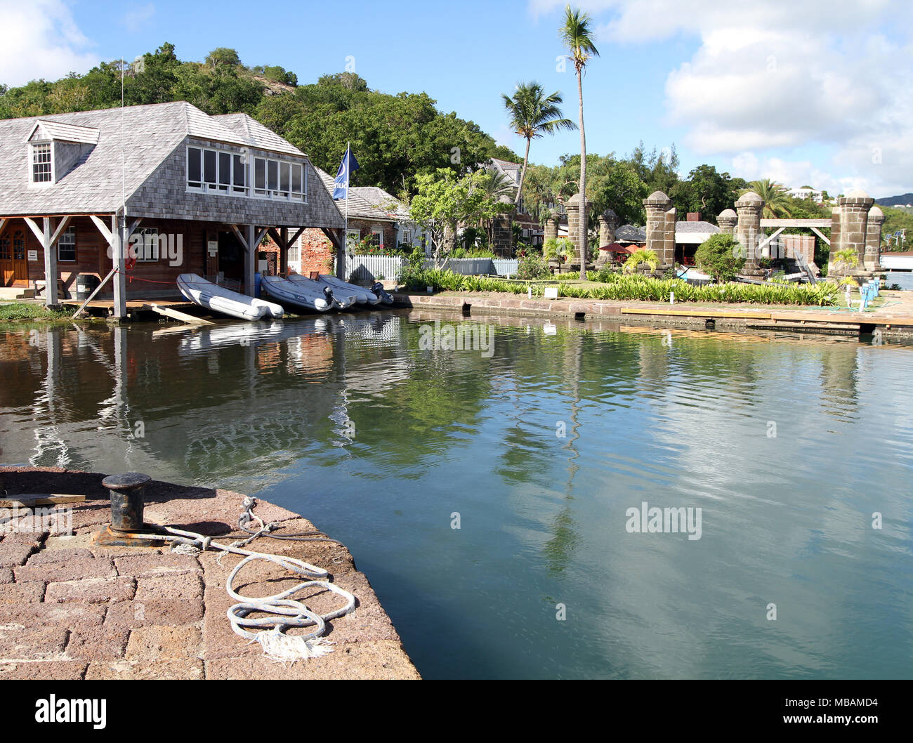 view over water of historic Nelsons Dockyard with reflections Stock Photo