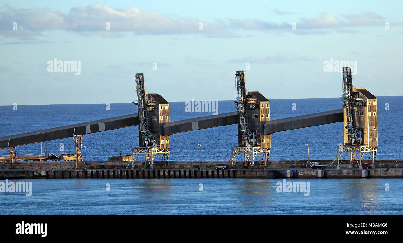 grain elevators along dock in harbor forming repeating pattern Stock Photo
