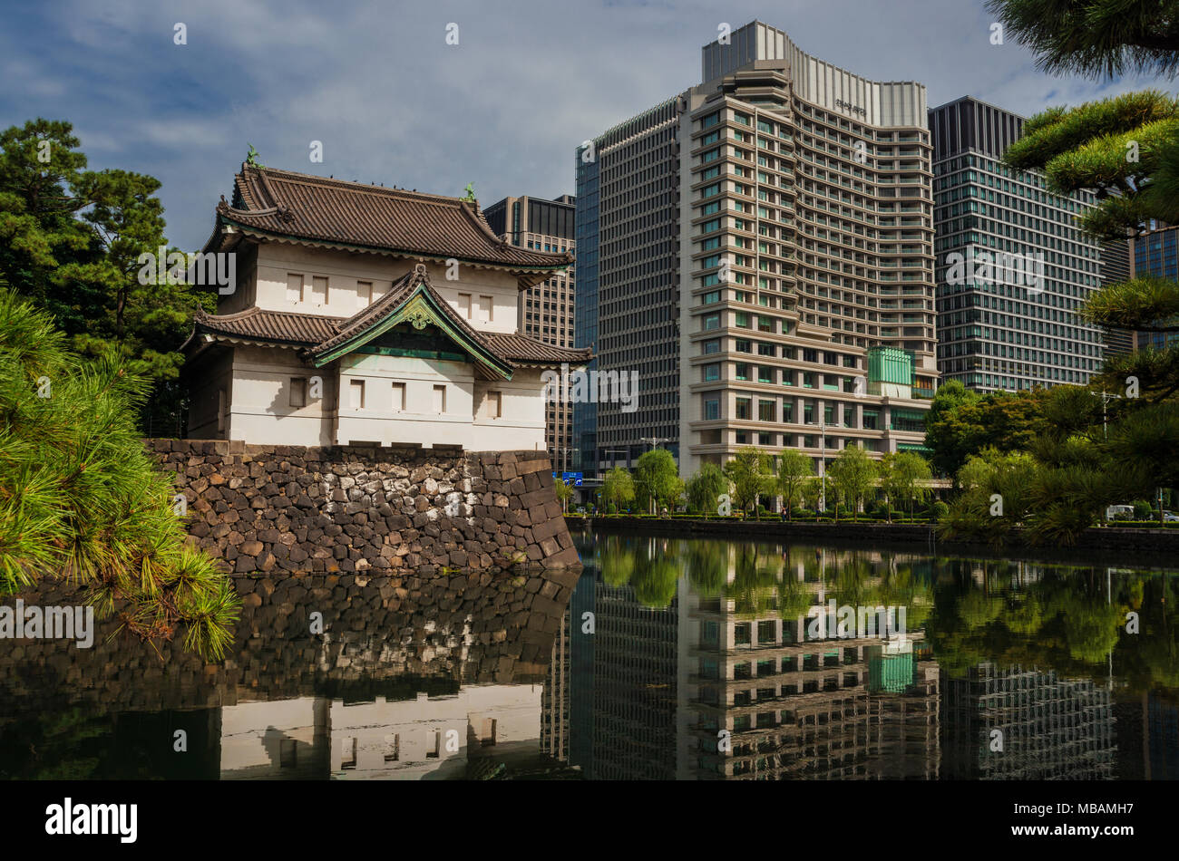 Tradition and Modernity in Japan. View of Imperial Palace old tower with the modern buildings side by side in central Tokyo Stock Photo