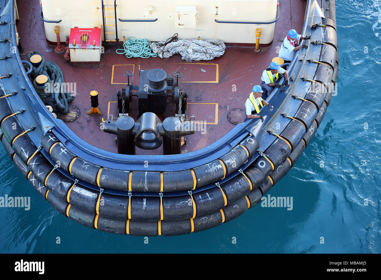detail of stern of tug boat showing rubber bumpers, winch, dolphins and