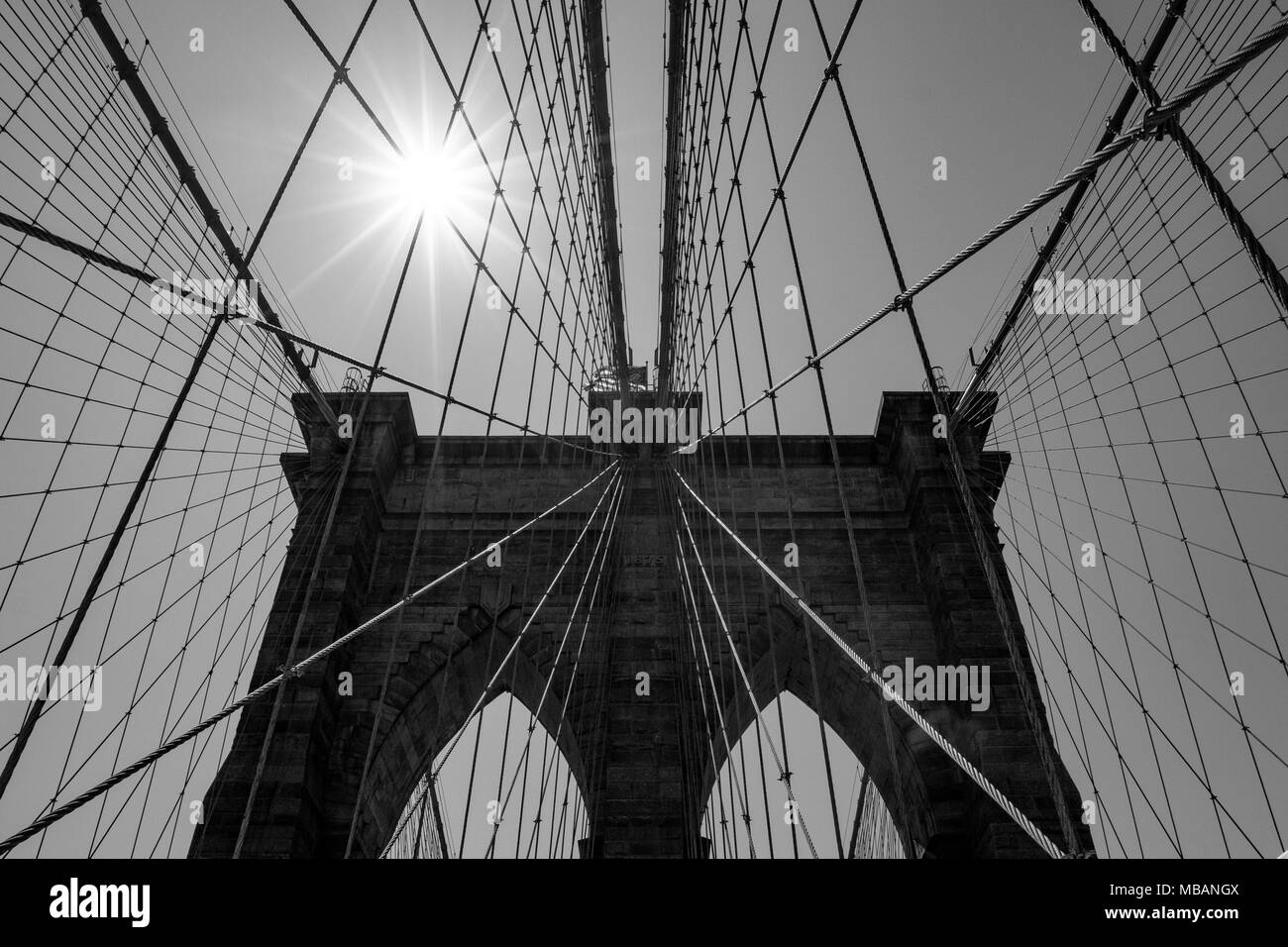 Details of the brooklyn bridge and the sun in black and white Stock Photo
