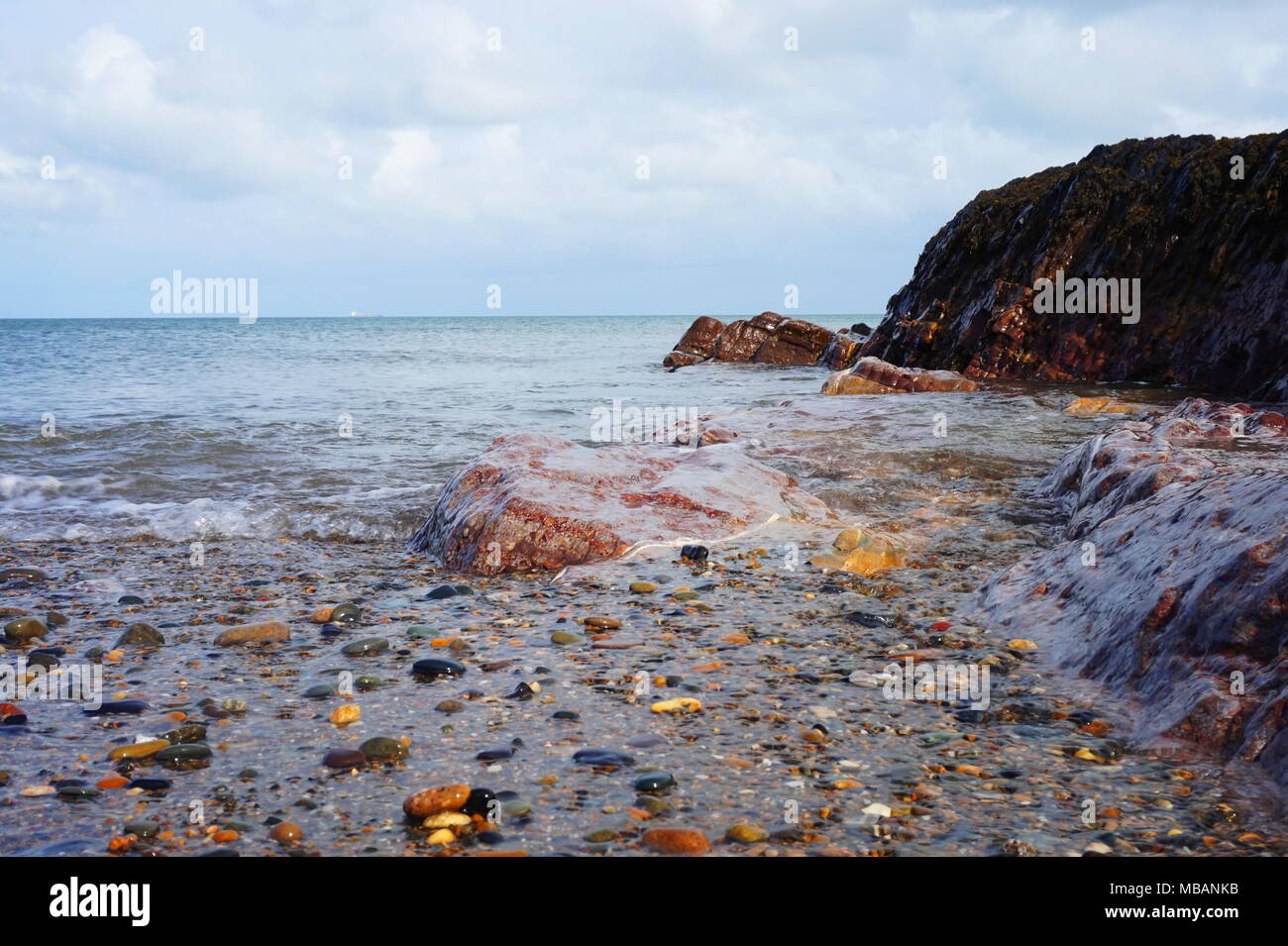 Picture taken at a UK beach in Springtime. Water makes the textures look shiny and smooth resulting in a beautiful piece with amazing color. Stock Photo