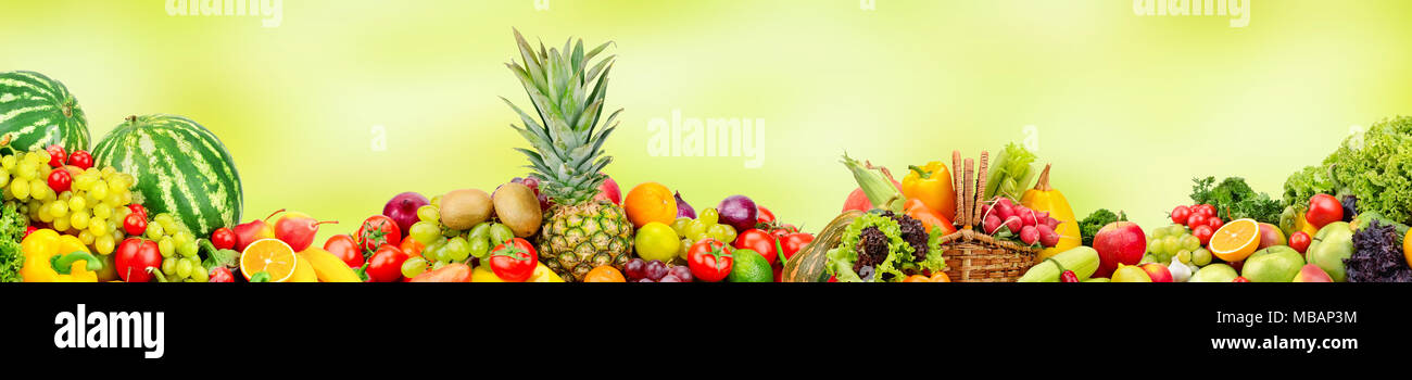 Panoramic wide collection fruits and vegetables for skinali on blur green background Stock Photo