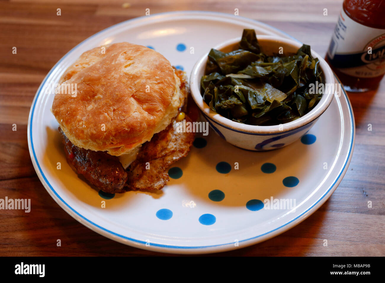 Peach jam, fried Egg and sausage biscuit with a side of collard greens at Seattle Biscuit Company, Seattle, Washington. Stock Photo