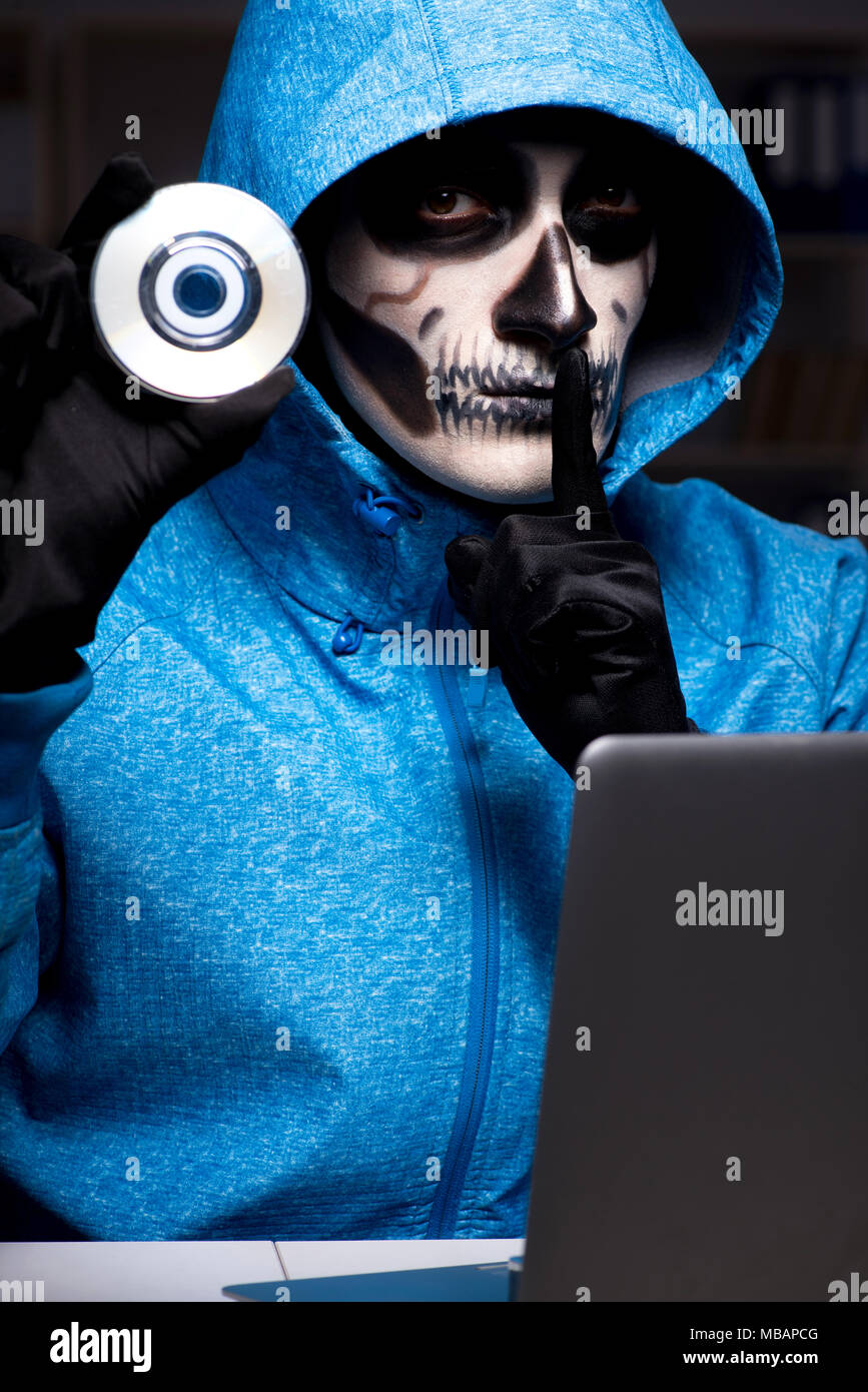 Scary hacker hacking security firewall late in office Stock Photo - Alamy