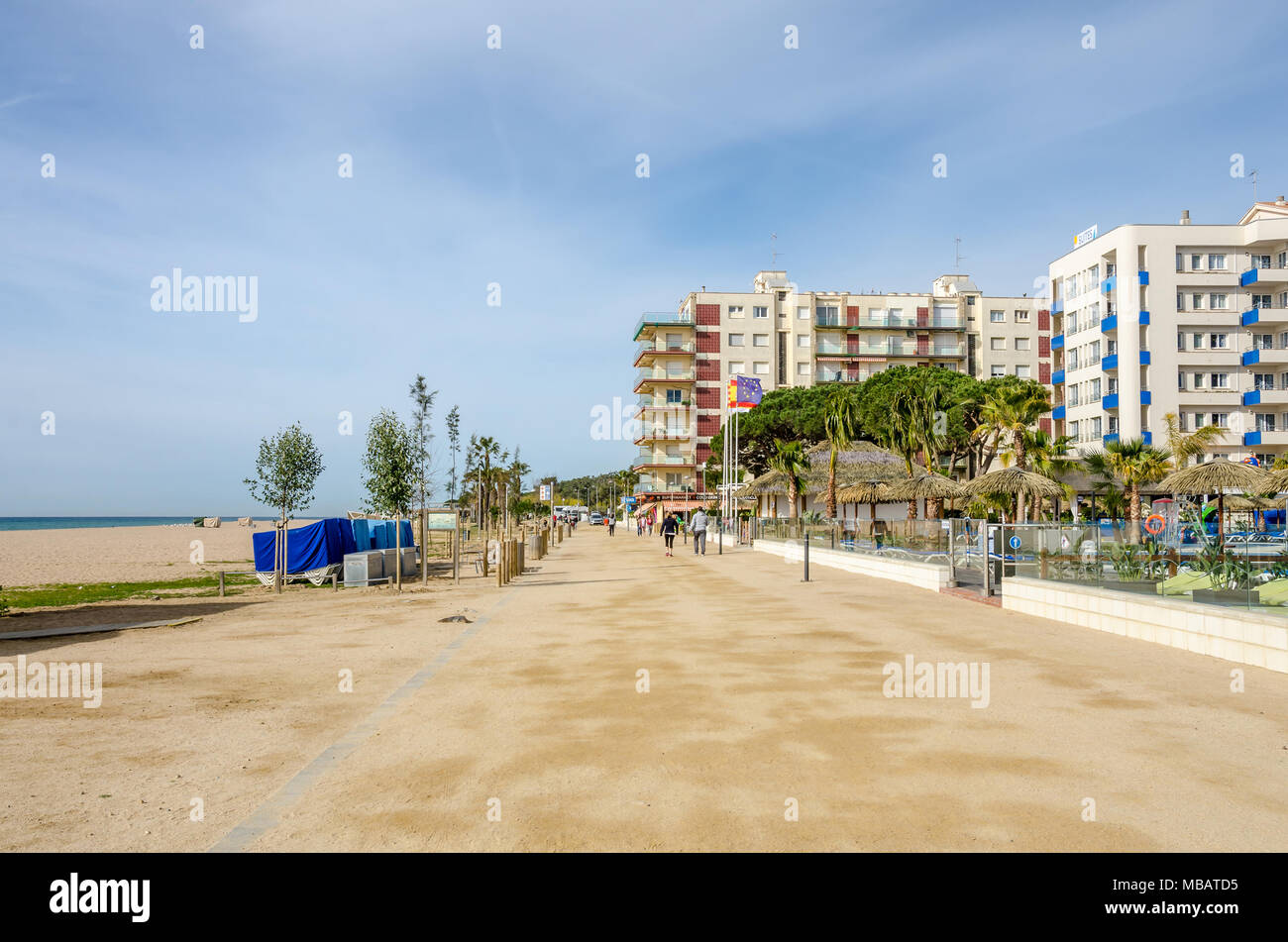 A view along an empty, sandy beach at Santa Susanna in the Costa Brava region of Spain. Hotels sit along the beach front Stock Photo