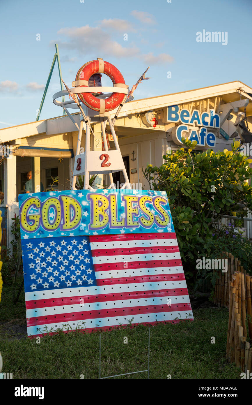 Cute beach cafe on Anglin's pier in Lauderdale by the Sea, Florida. American flag sign with God Bless painted on it. Stock Photo