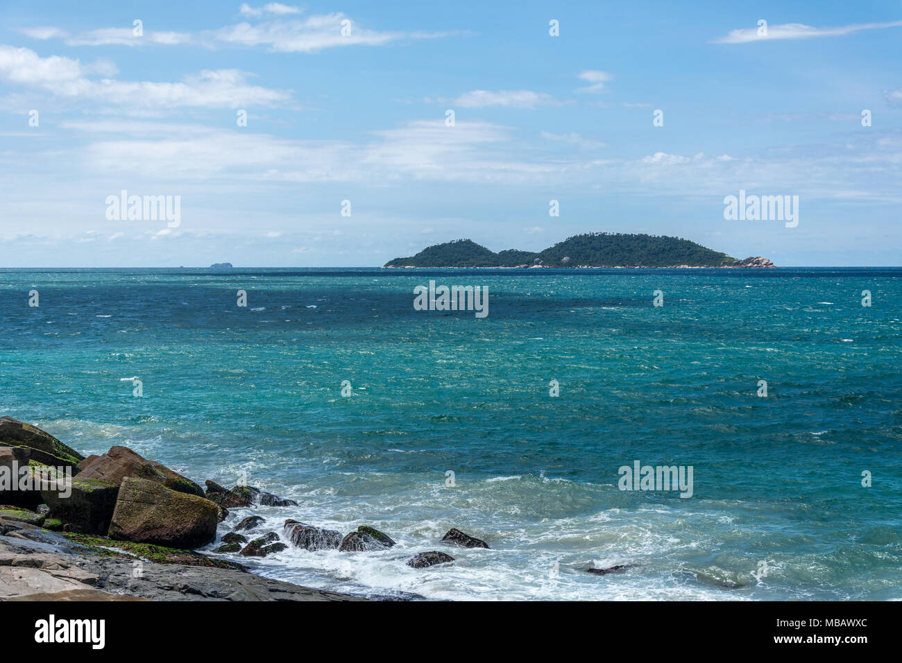 Florianopolis, Brazil. February, 2018. Sea and rocky region at the south of the island. At the backside of the image, the Campeche Island (Ilha do Cam Stock Photo