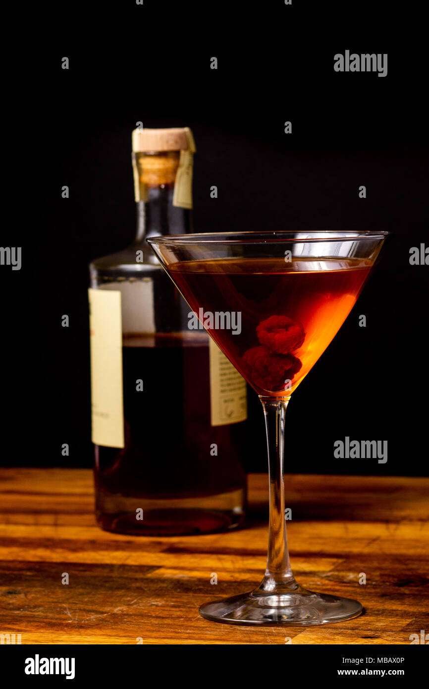 cocktail with bottle with dark setting and black background Stock Photo