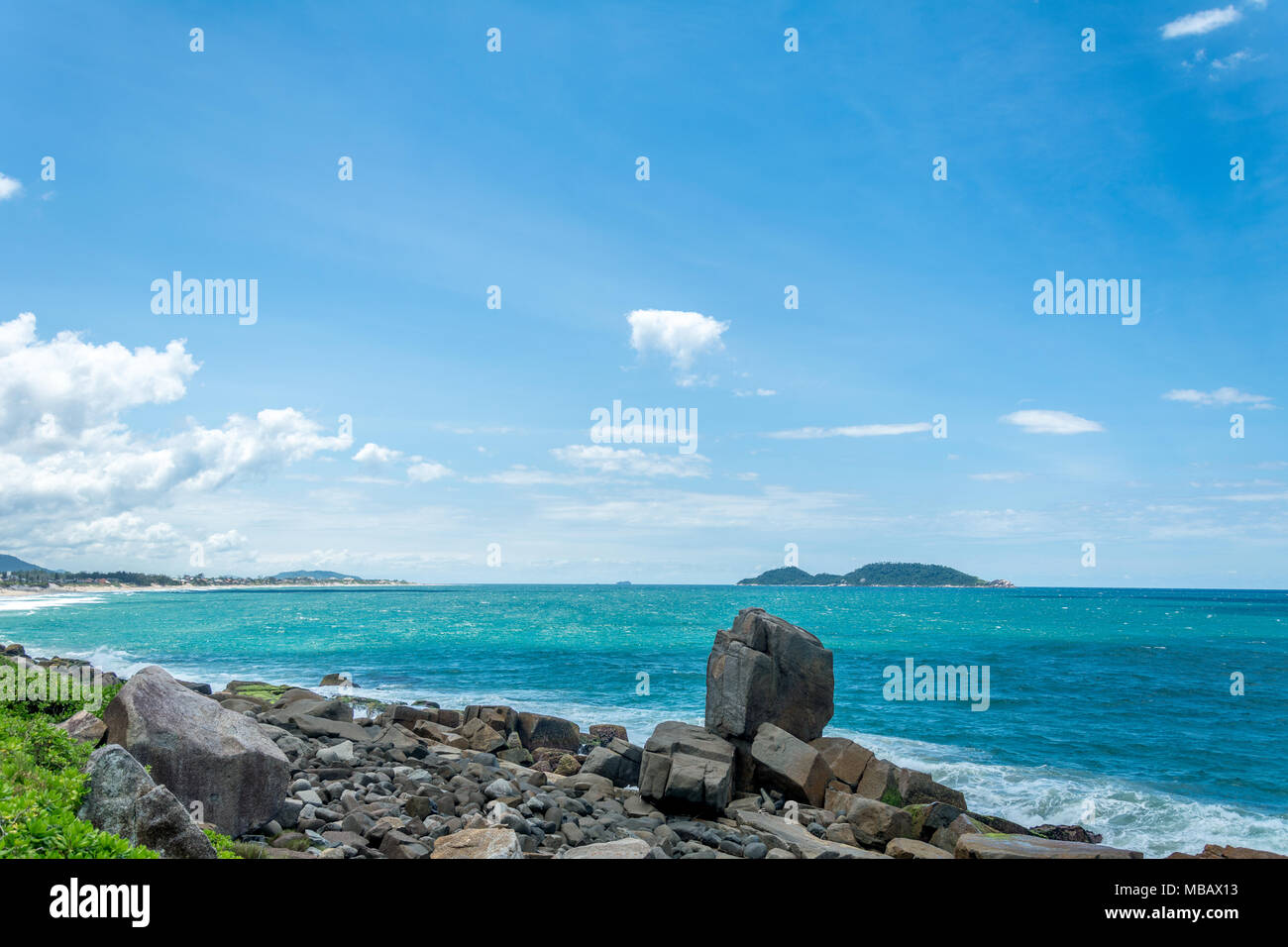 Florianopolis, Brazil. February, 2018. Sea and rocky region at the south of the island. At the backside of the image, the Campeche Island (Ilha do Cam Stock Photo