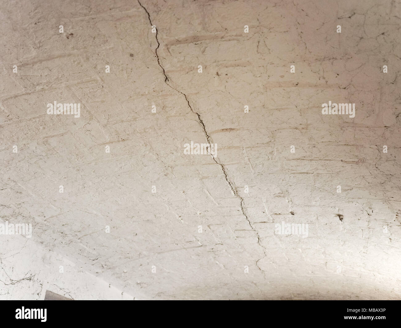 crack in a brick vault ceiling caused by excessive settling due to bad