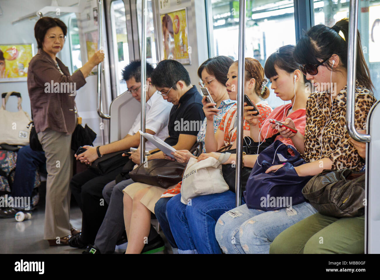 Tokyo Japan,Ikebukuro,Ikebukuro Station,JR Yamanote Line,train,subway,train,train,passenger passengers rider riders,Asian man,woman female women adult Stock Photo