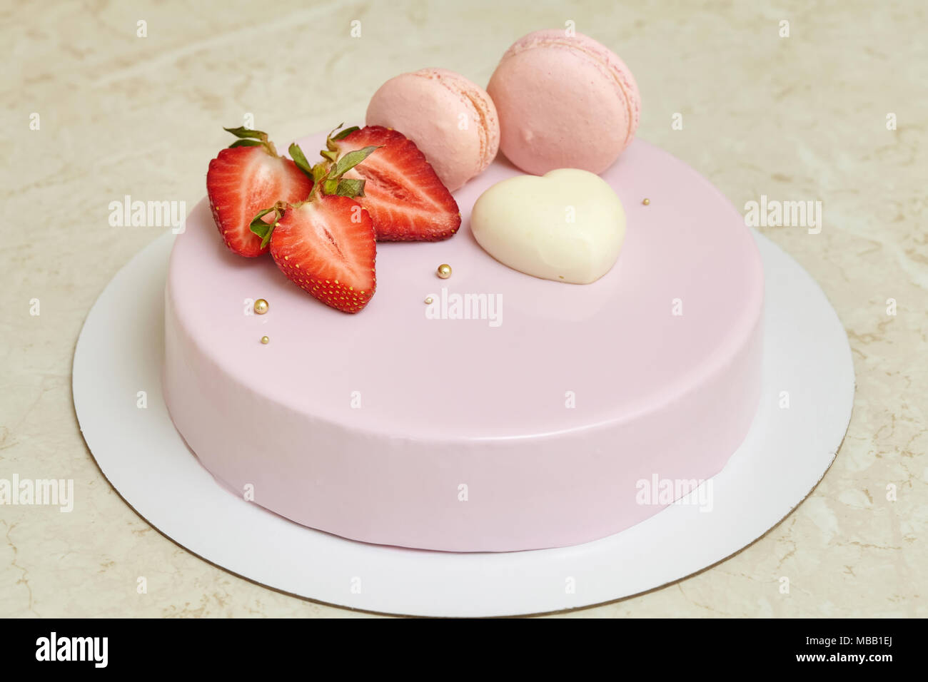 Mousse Cake With Pink Mirror Glaze Decorated With Heart Macarons