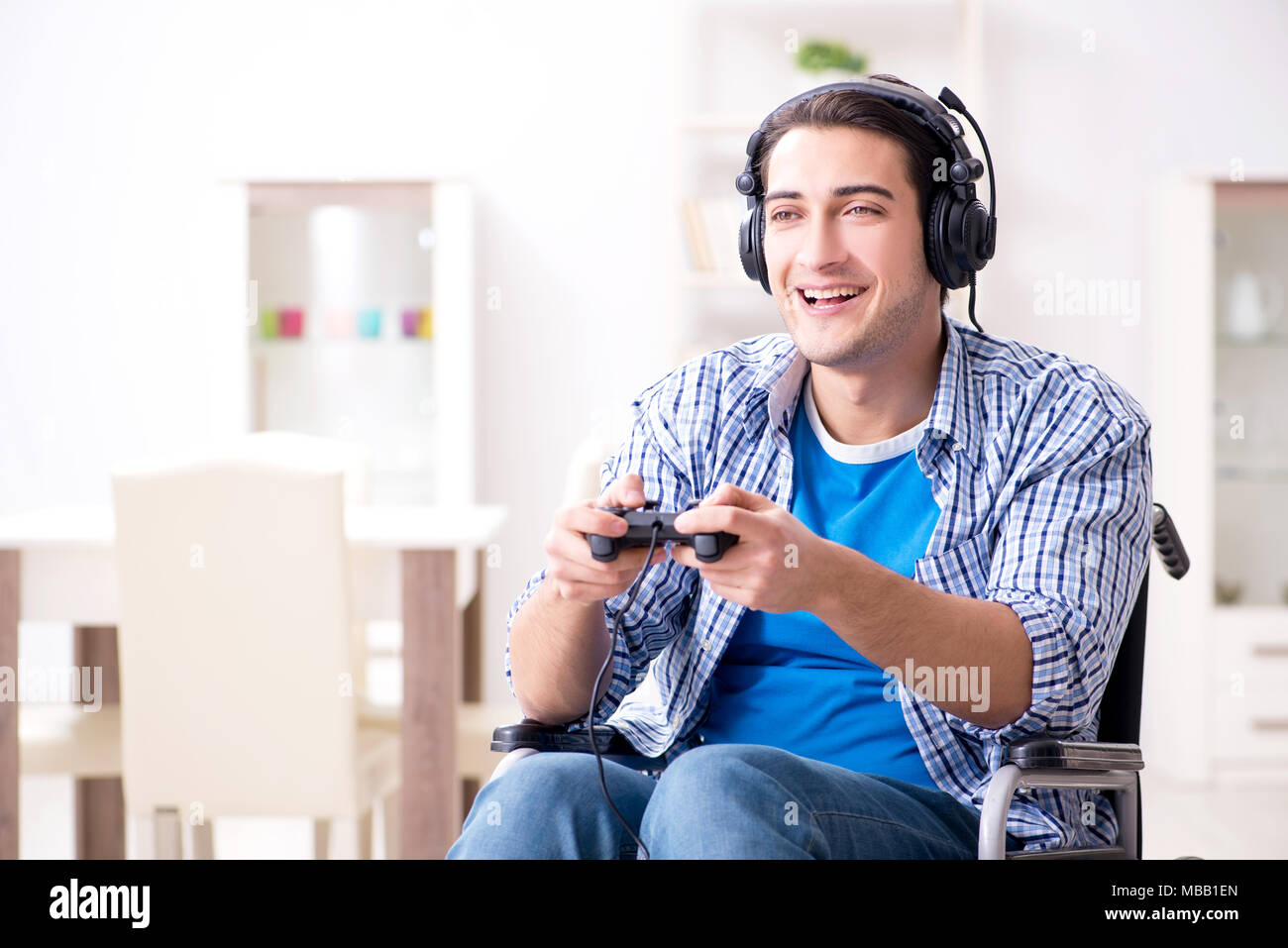 Disabled man playing computer games during rehabilitation Stock Photo