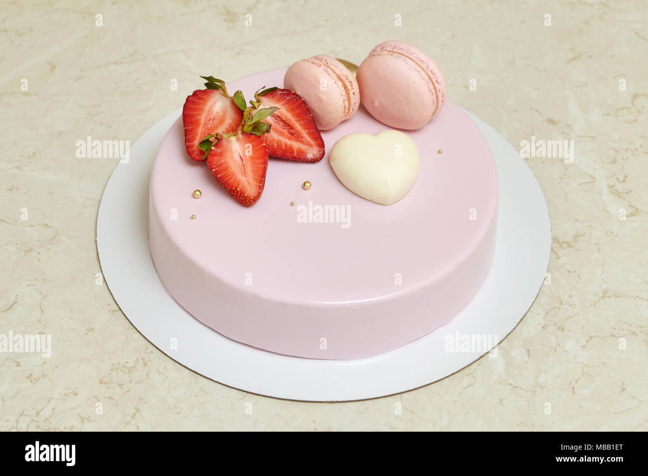 Mousse Cake With Pink Mirror Glaze Decorated With Heart Macarons