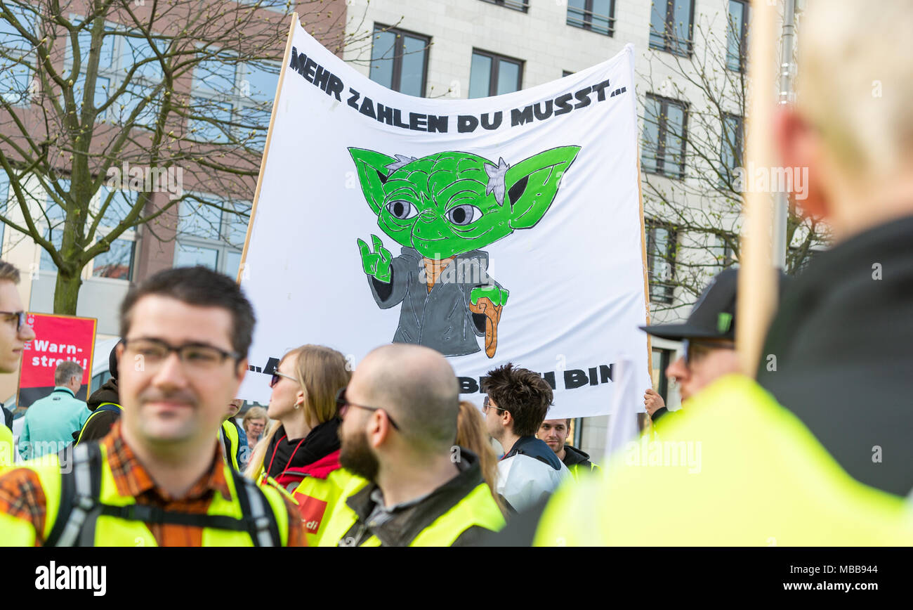 Berlin, Germany. 10th Apr, 2018. 10 April 2018, Germany, Berlin: Striking workers hold up a banner showing Star Wars character Yoda saying 'Mehr zahlen du musst' (lit. 'you must pay more'). Labour union Verdi called for large-scale public service strikes. Credit: Christophe Gateau/dpa/Alamy Live News Stock Photo