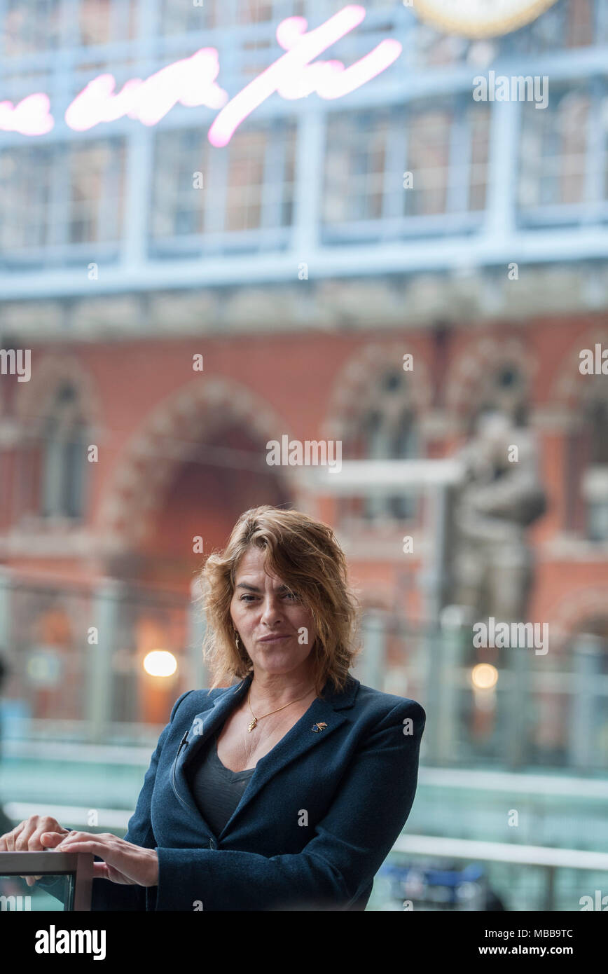 St Pancras station, London, UK. 10 April 2018. In celebration of the 150th anniversary of St Pancras International and the 250th anniversary of the RA, Tracey Emin CBE RA presents a free public Terrace Wires installation suspended from the station’s Victorian glass roof. The largest text piece she has ever made reminds travellers to stop and take a moment in one of the UK’s busiest railway stations. I Want My Time With You hangs directly below the St Pancras clock. Credit: Malcolm Park/Alamy Live News. Stock Photo