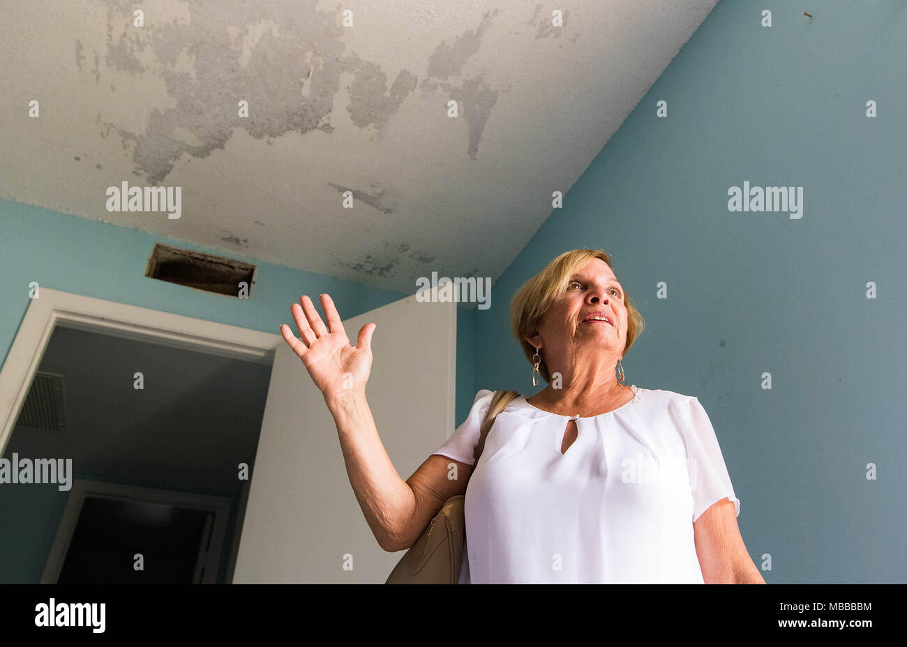 April 10, 2018 - Palm Beach Gardens, Florida, U.S. - Martha Zuniga, owner of a Sandalwood Estates condo that was damaged by hurricane Irma, is still waiting to do repairs until the roof leak is fixed in Palm Beach Gardens, Florida on April 9, 2018. Seven months after Hurricane Irma, fewer than half of the 39,000 claims in Palm Beach County have been closed with payment. Florida's second largest insurer Citizens has reopened more than 24,000 claims, or about 37 percent, statewide to review whether homeowners deserve more payment. (Credit Image: © Allen Eyestone/The Palm Beach Post via ZUMA Wire Stock Photo