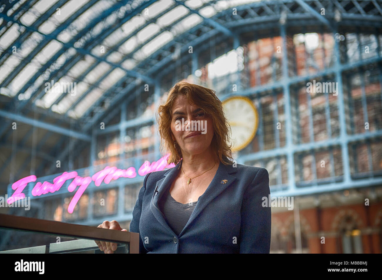 St Pancras International station, London, UK. 10 April 2018. In celebration of the 150th anniversary of St Pancras International and the 250th anniversary of the RA, Tracey Emin CBE RA presents a free public Terrace Wires installation suspended from the station’s Victorian glass roof. The largest text piece she has ever made reminds travellers to stop and take a moment in one of the UK’s busiest railway stations. I Want My Time With You hangs directly below the St Pancras clock. Credit: Malcolm Park/Alamy Live News. Stock Photo