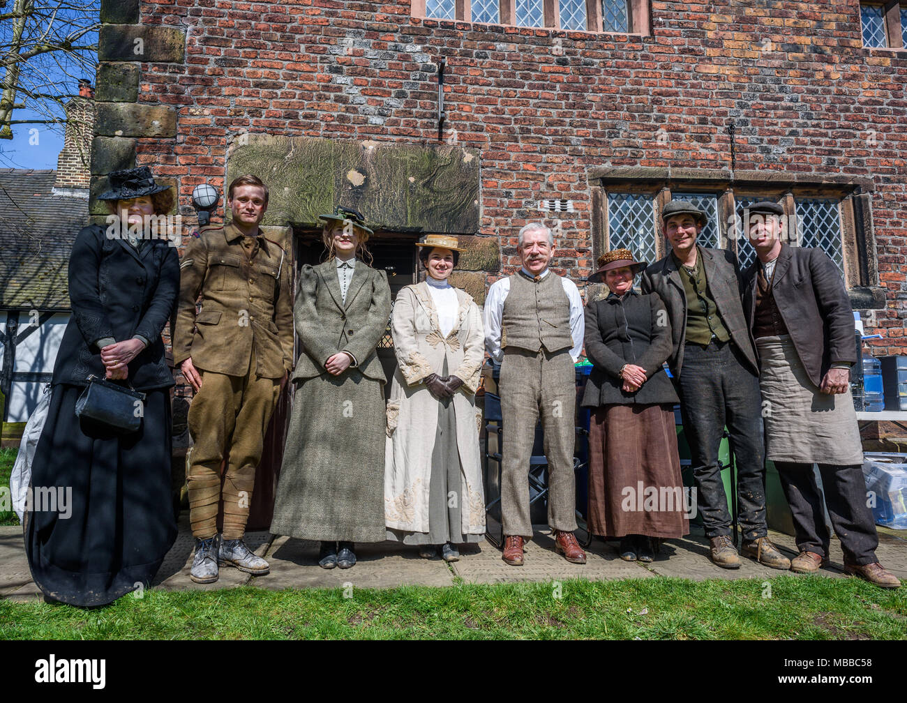 Great Budworth, UK. 9th April, 2018. extras taking a break pose dressed in Edwardian costumes in Village churchyard, starring in the new BBC drama 'War Of The Worlds' by HG Wells,filmed at Great Budworth village, Cheshire on Monday afternoon, April 9th. Credit: Ian Hubball/Alamy Live News Stock Photo