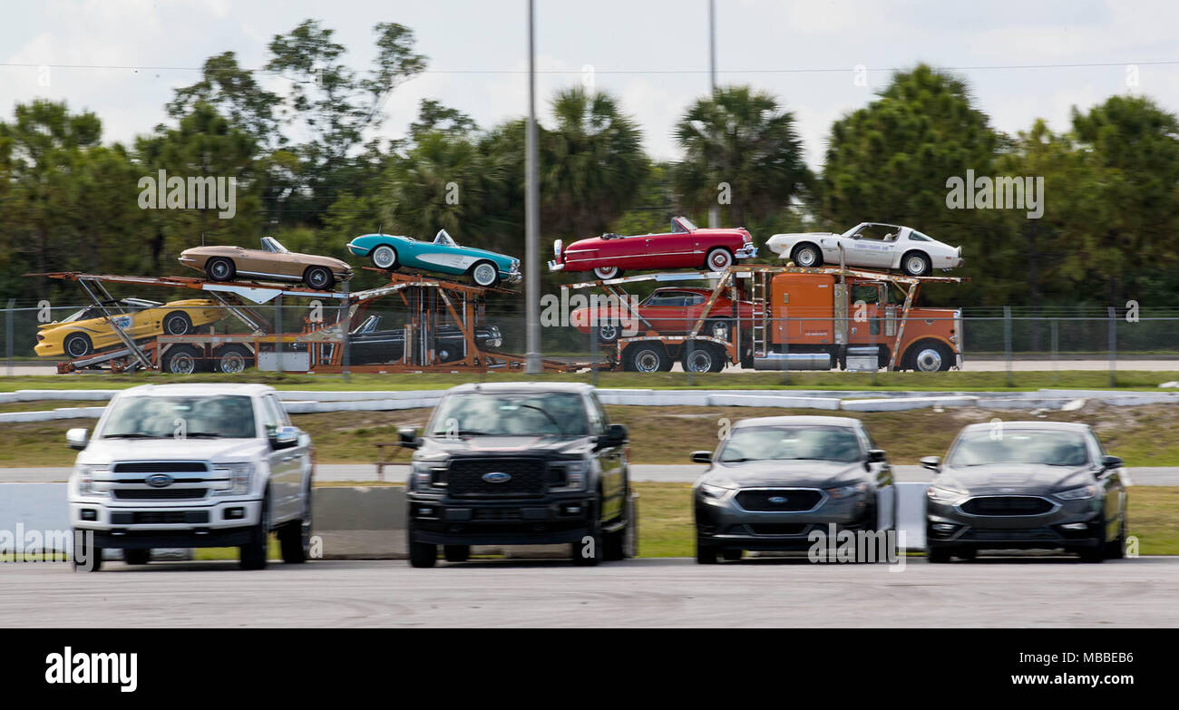 April 10, 2018 - West Palm Beach, Florida, U.S. - A trailer carrying some of the 140 cars owned by John Staluppi arrives at Barrett-Jackson auto auction at the South Florida Fairgrounds in West Palm Beach, Florida on April 10, 2018. Staluppi chaperoned a parade of selected cars from his Cars of Dreams Collection to the auto auction. Staluppi's collection of more than 140 cars will be sold at the 16th annual auction April 12-15. Staluppi plans to add to his current collection. (Credit Image: © Allen Eyestone/The Palm Beach Post via ZUMA Wire) Stock Photo