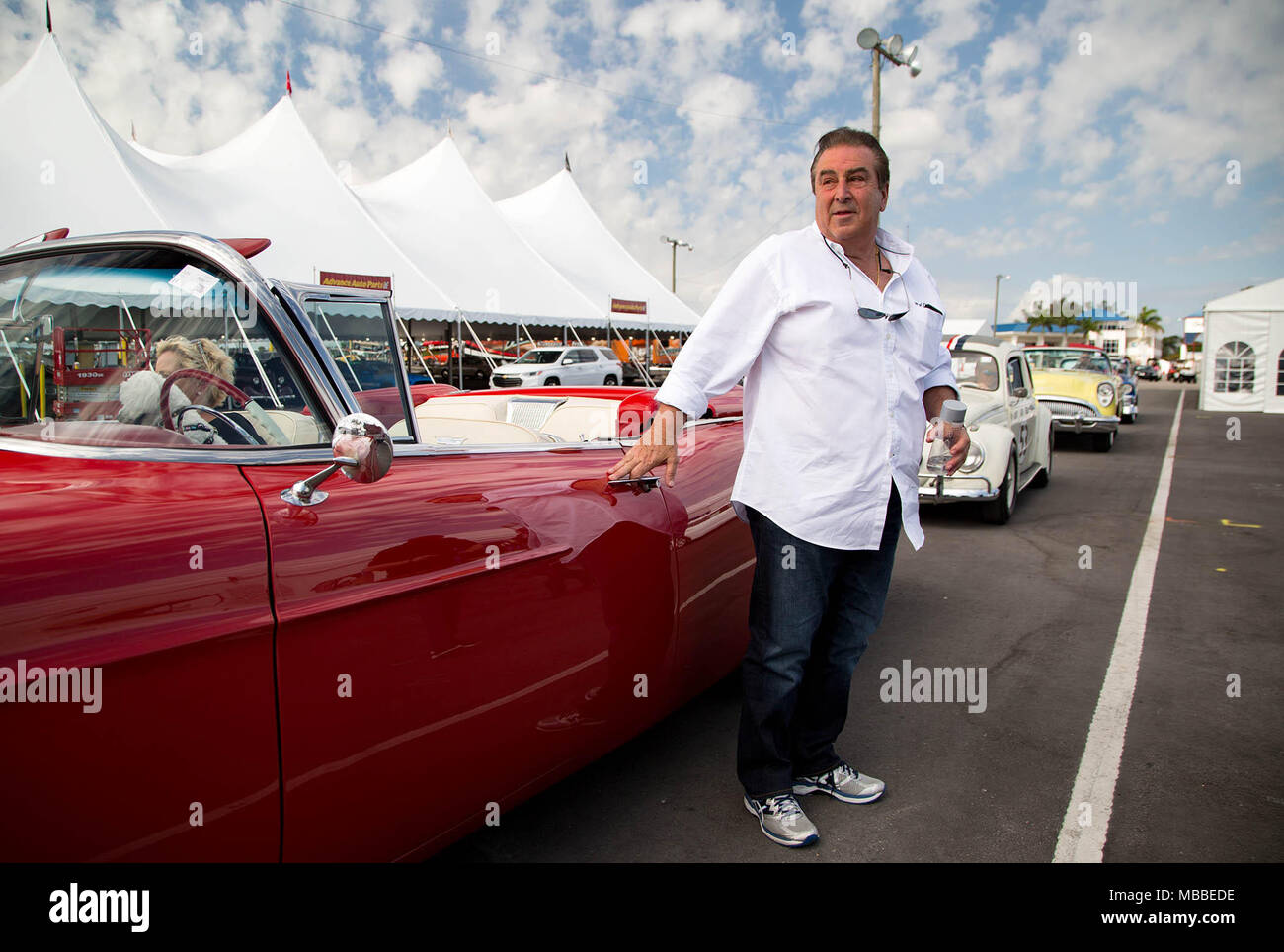 West Palm Beach, Florida, USA. 10th Apr, 2018. John Staluppi with his wife, Jeanette, and dog, Buddy, arrive at Barrett-Jackson auto auction at the South Florida Fairgrounds in a 1957 Cadillac Eldorado Biarritz convertible in West Palm Beach, Florida on April 10, 2018. Staluppi chaperoned a parade of selected cars from his Cars of Dreams Collection to the auto auction. Staluppi's collection of more than 140 cars will be sold at the 16th annual auction April 12-15. Staluppi plans to add to his current collection. Credit: Allen Eyestone/The Palm Beach Post/ZUMA Wire/Alamy Live News Stock Photo