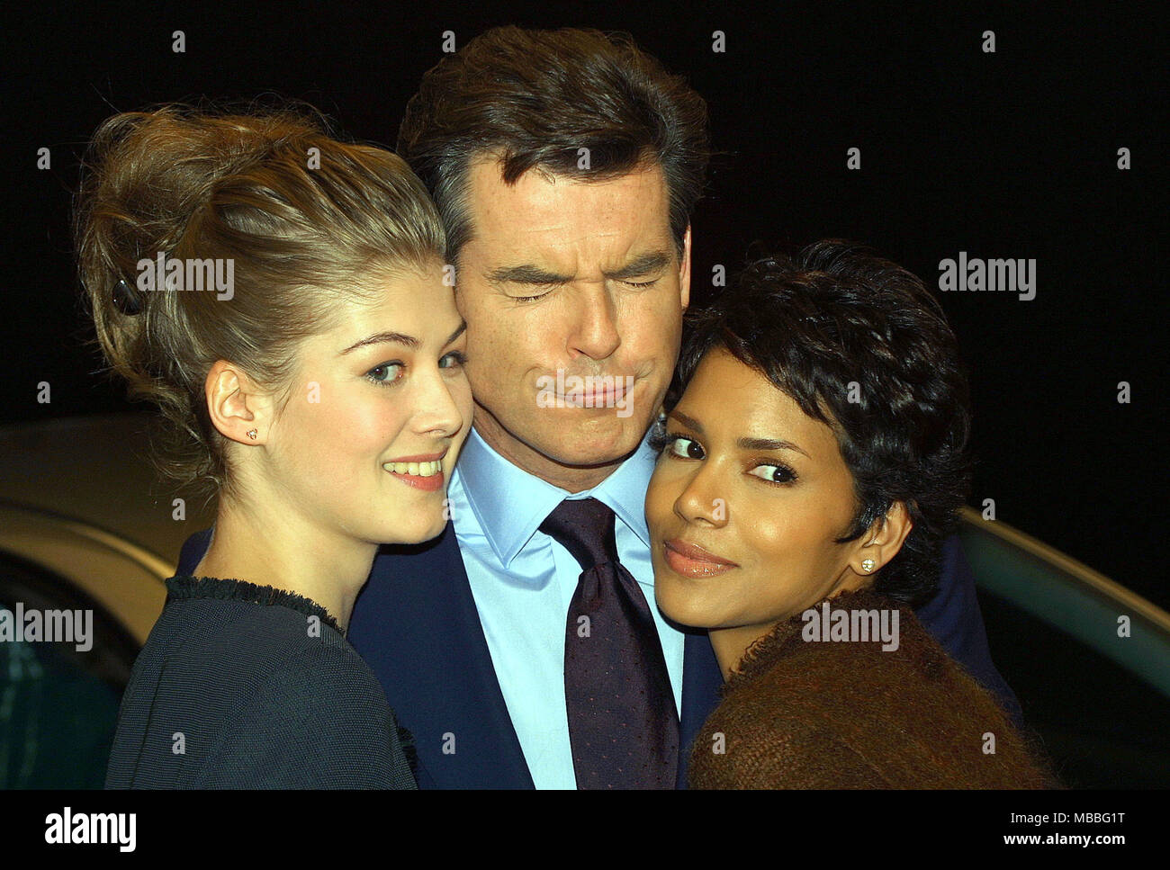 Pierce Brosnan at the Pinewood Studios for the James Bond film Die Another Day  with Rosamund Pike (left) and Halle Berry Stock Photo