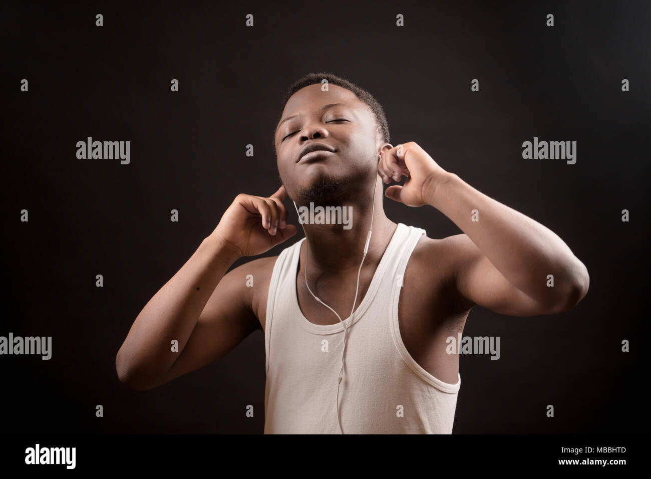 young African male listening to music with closed eyes Stock Photo