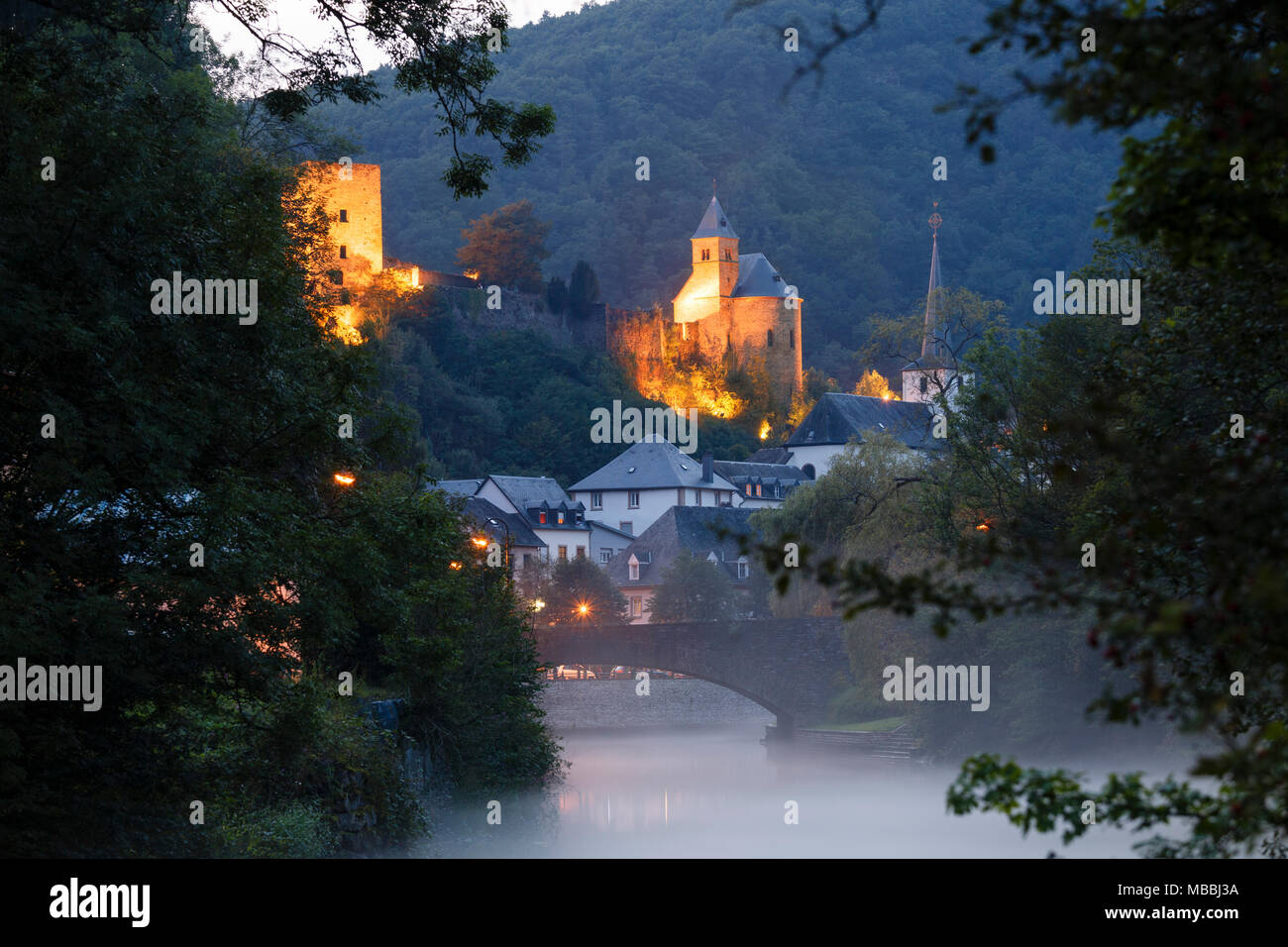 A summer evening mist rises off the river at Esch-sur-Sûre, Luxembourg Stock Photo