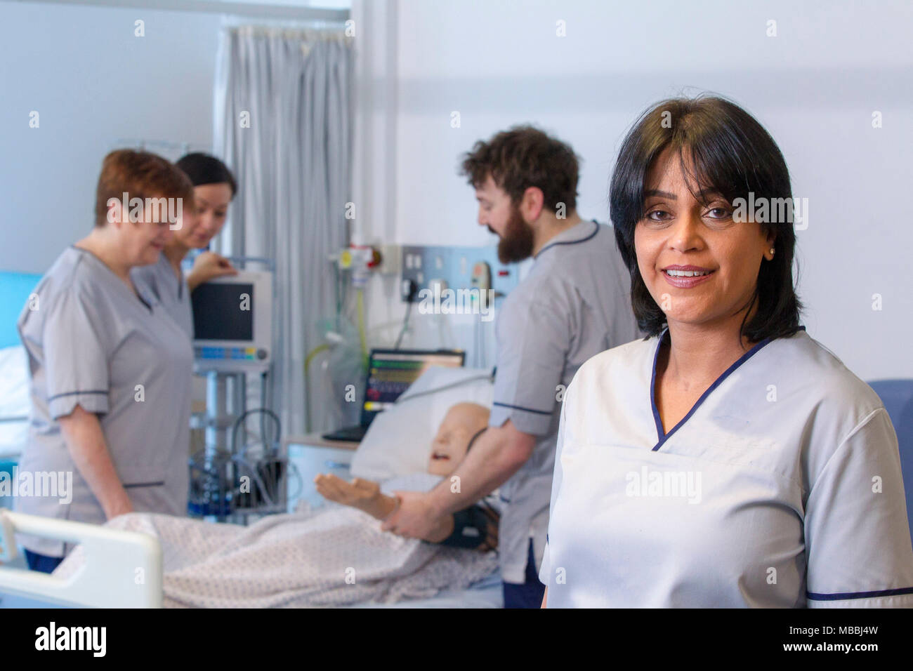 Mature student nurses training in ward situation Stock Photo