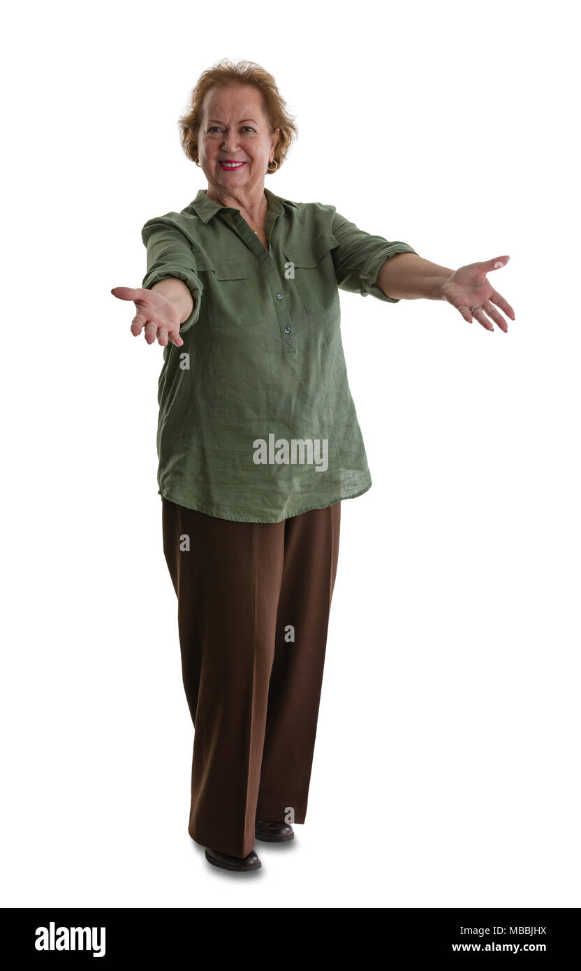 Portrait of senior woman doing welcoming gesture while standing against white background Stock Photo