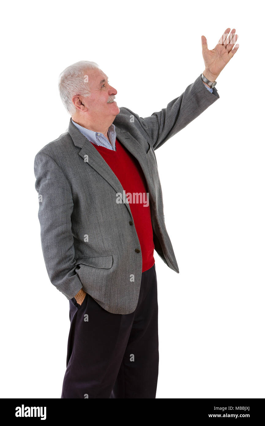 Senior grey-haired man raising his left arm showing something with a smile in a side profile view isolated on white Stock Photo