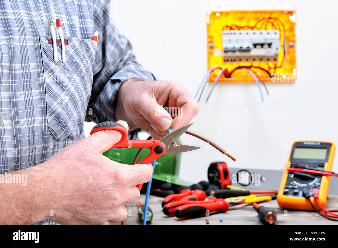 Electrician technician at work in a residential electric installation