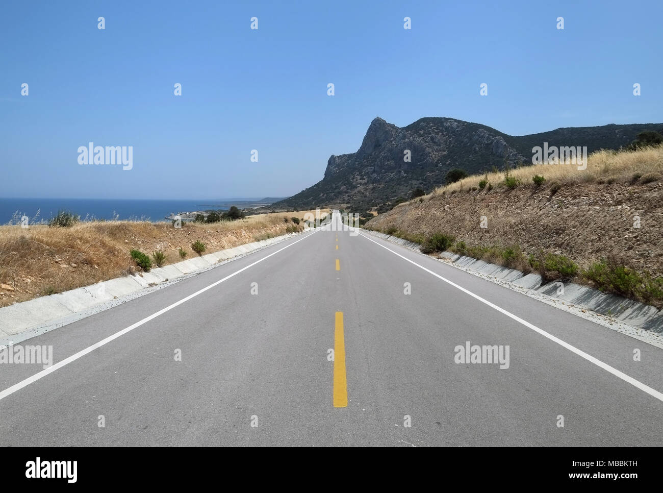 Long straight main road on the Karpass Peninsula, Northern Cyprus. Stock Photo