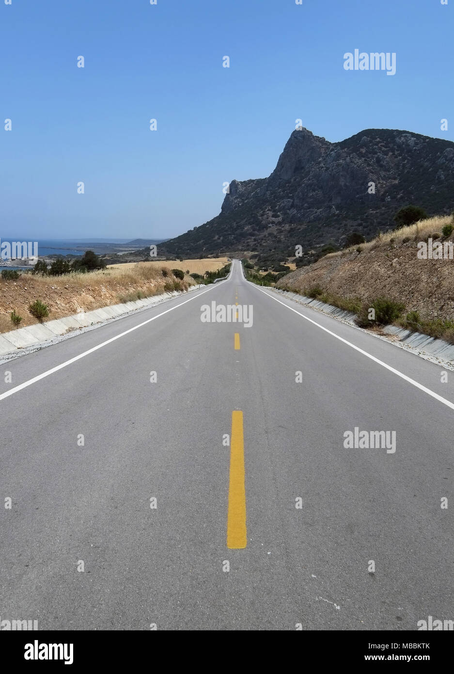 Long straight main road on the Karpass Peninsula, Northern Cyprus. Stock Photo