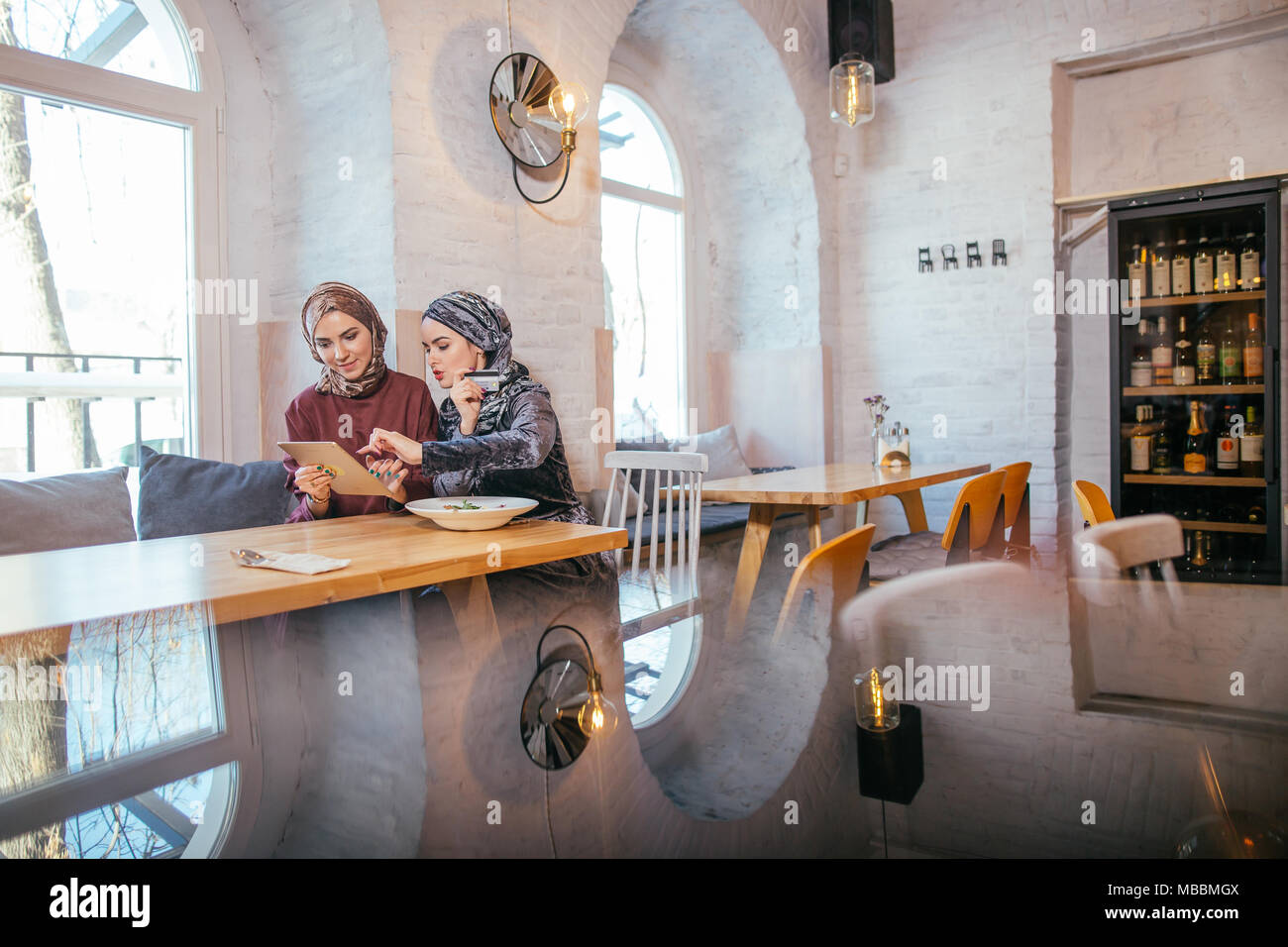 two business partner using tablet in front of their coffee shop Stock