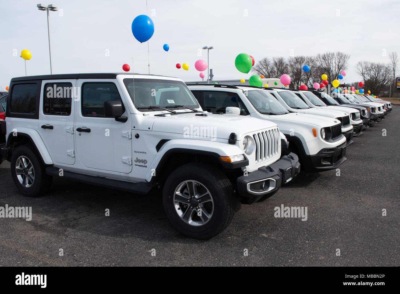 A line of new Jeep Wranglers and Renegades for sale on a dealers car lot in  Amsterdam, NY USA with advertising balloons to attract attention Stock  Photo - Alamy