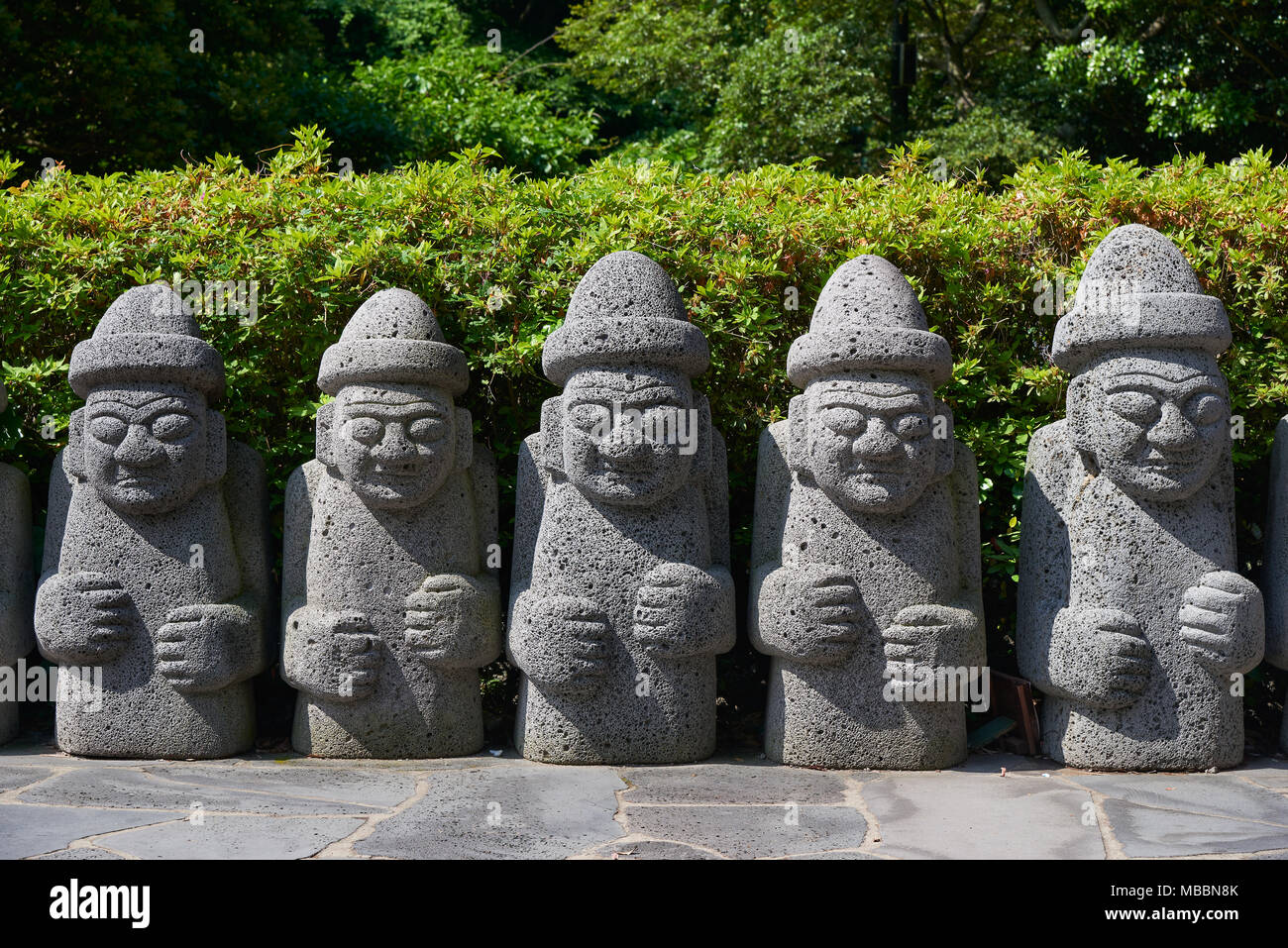 Jeju, Korea - May 25, 2017: Dol Hareubang, local traditional large rock statues. They are considered to be gods offering protection and fertility. Stock Photo