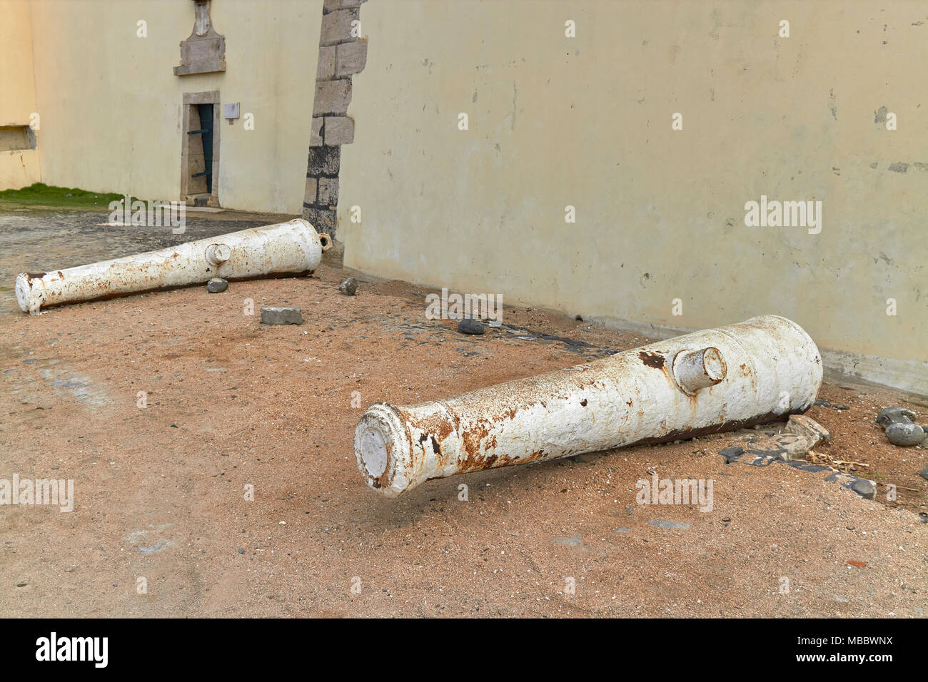 A Pair of Canons lying next to the Wall of the Sao Sebastiao Fort in Sao Tome Town, on Sao Tome et Principe, West Africa, Stock Photo