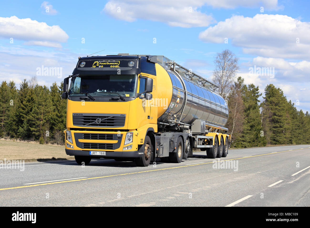 LIETO, FINLAND - MAY 13, 2017: Yellow Volvo FH semi tanker for food transport on Highway 10 on a beautiful day of spring in South of Finland. Stock Photo