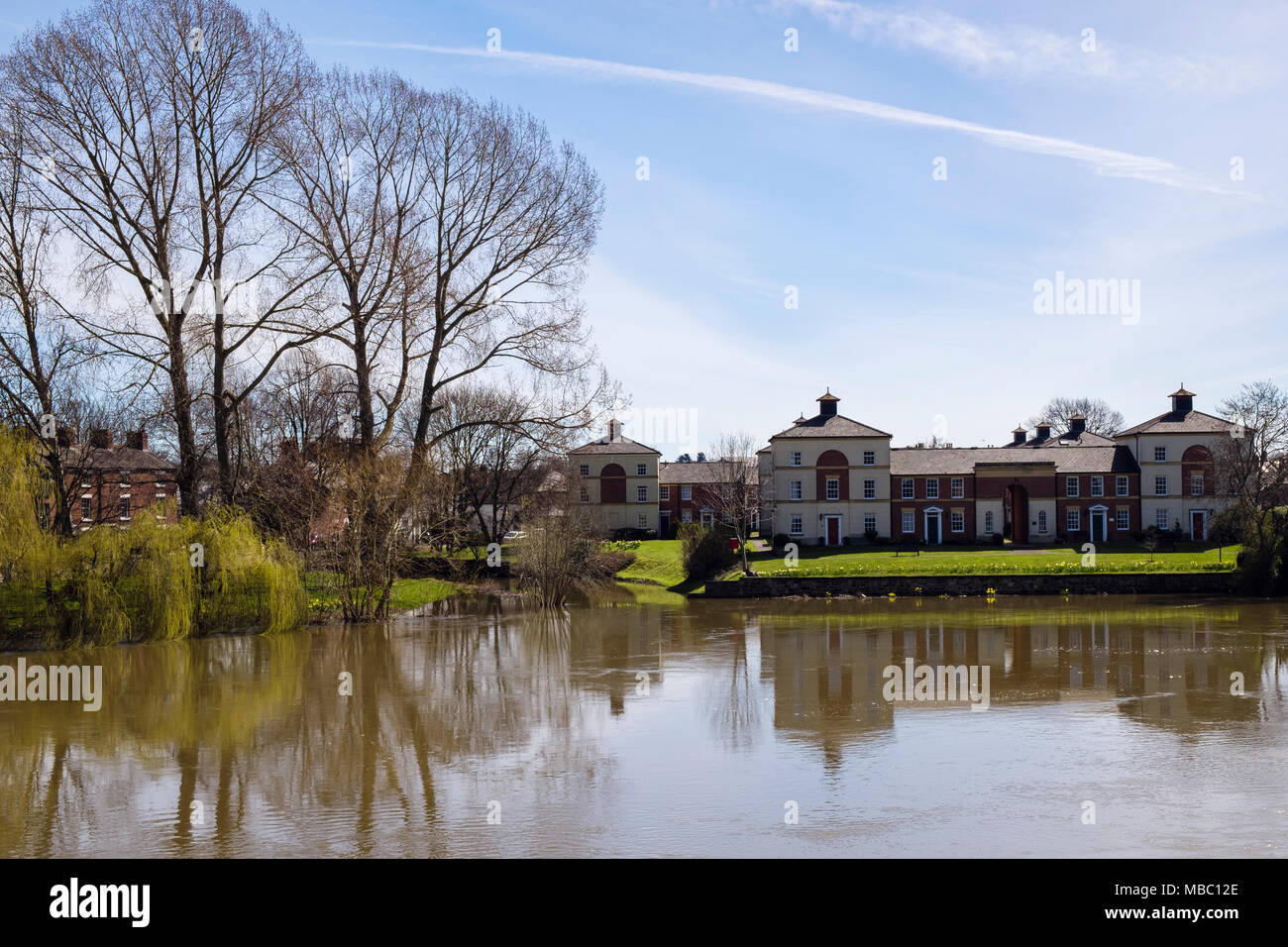 Modern riverside town houses overlooking the River Severn in flood