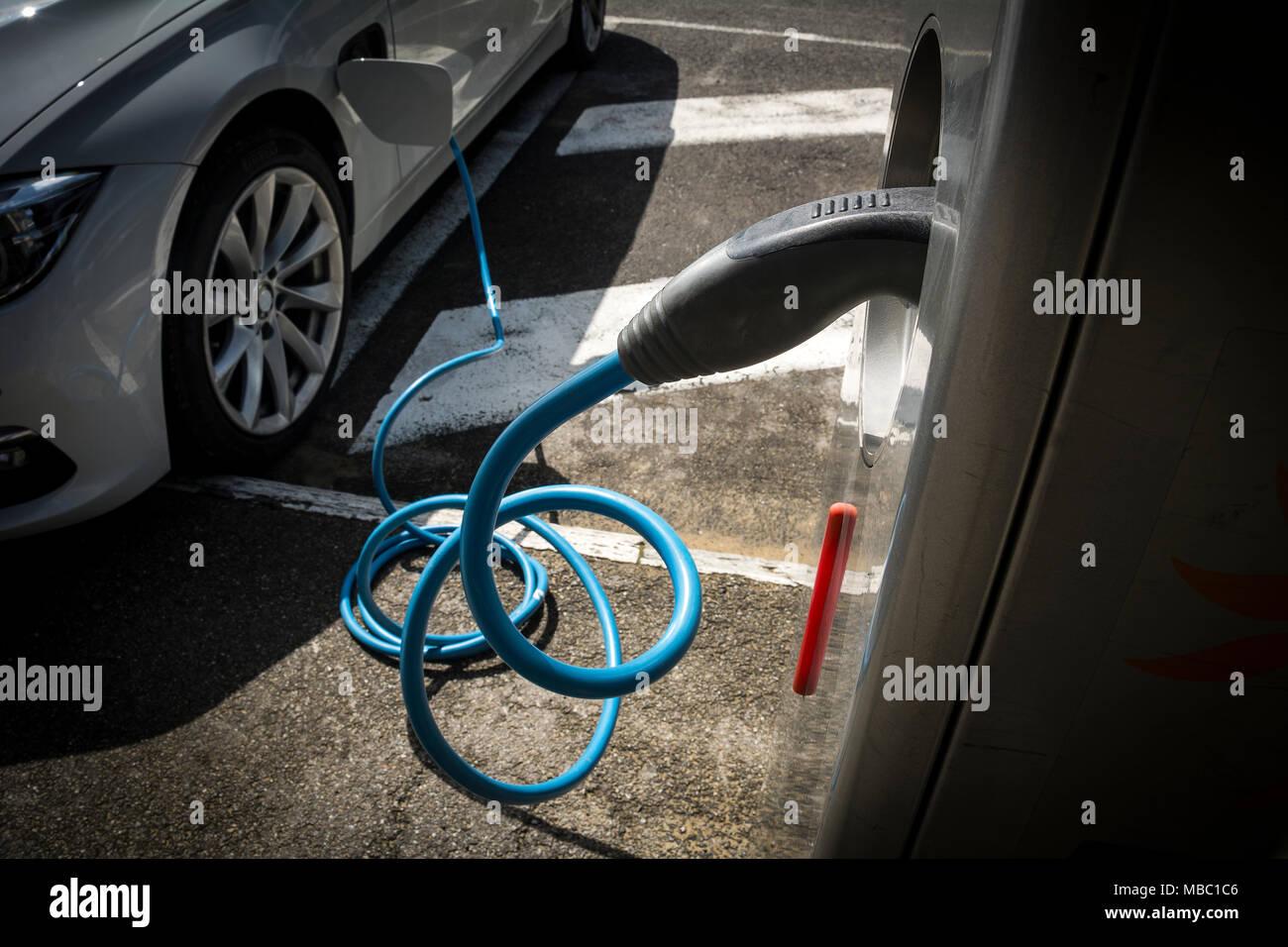 Electric car charging station topping up car battery Stock Photo Alamy
