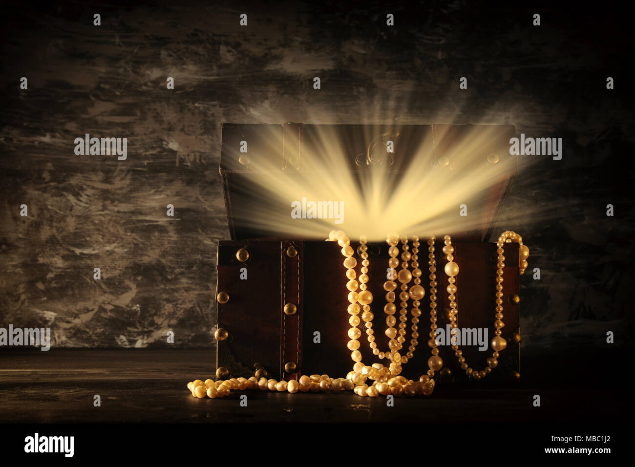 Image of mysterious opened old wooden treasure chest with light. An ...