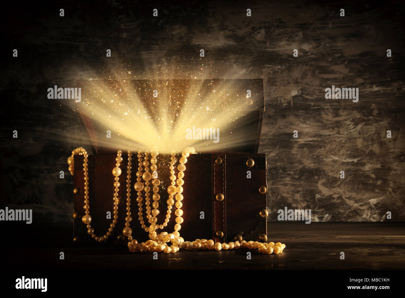 Image of mysterious opened old wooden treasure chest with light. An ...