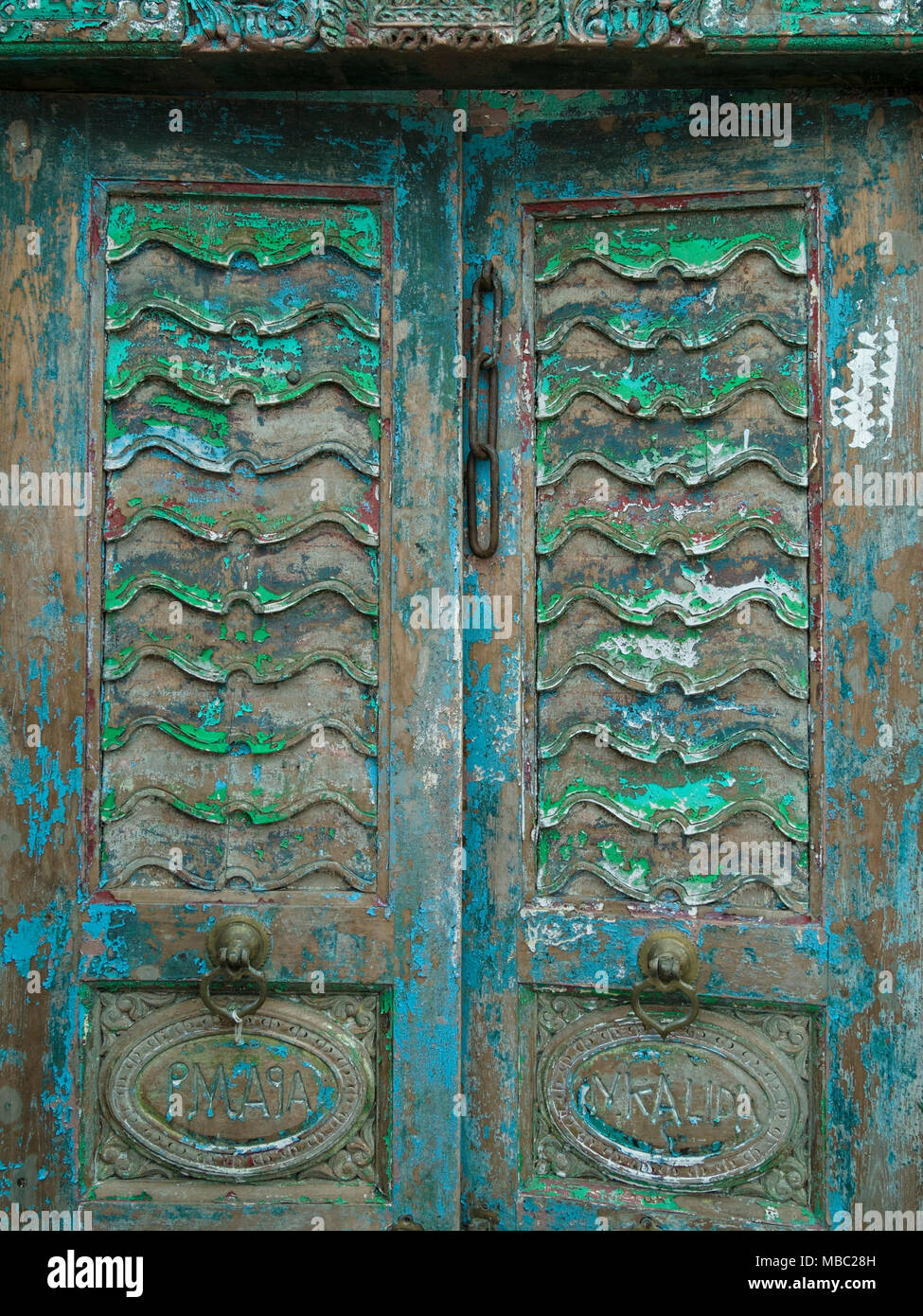 Old Distressed Ornate Antique Wooden Double Doors In Garden Classics Old distressed ornate antique wooden double doors in Garden Classics reclamation Yard, Ashwell, Rutland, UK - Old Distressed Ornate Antique Wooden Double Doors In Garden Classics