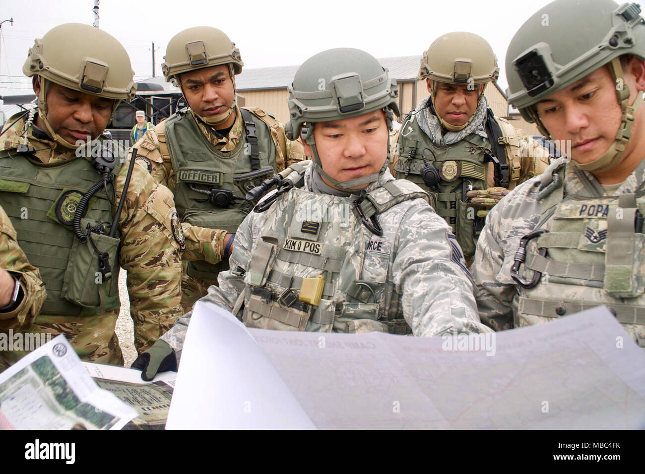 Master Sgt. Robert Kim, Vice Troop Commander for Patriot South exercise, looks over a map of their training grounds with the Mississippi Department of Wildlife, Fisheries and Parks Special Response Team to plan their next steps for the exercise, Feb. 13, 2018, at Camp Shelby, Mississippi. Patriot South focuses on increasing the understanding of coordination, policies, and procedures required in conducting a Joint-Inter-Agency Domestic response. (U.S. Air National Guard Stock Photo