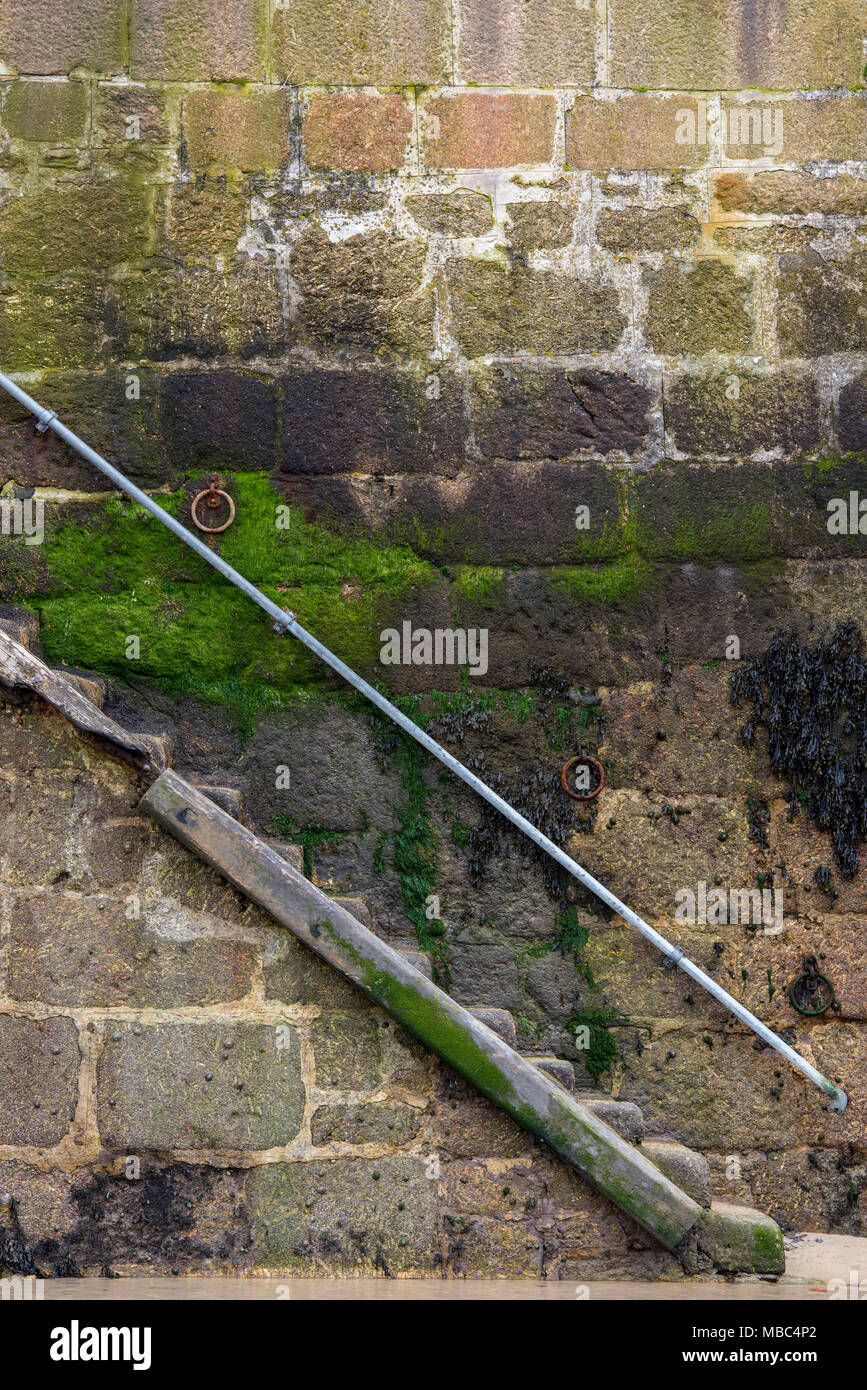 A set or flight of steps or stairs made of stone on the harbour wall at