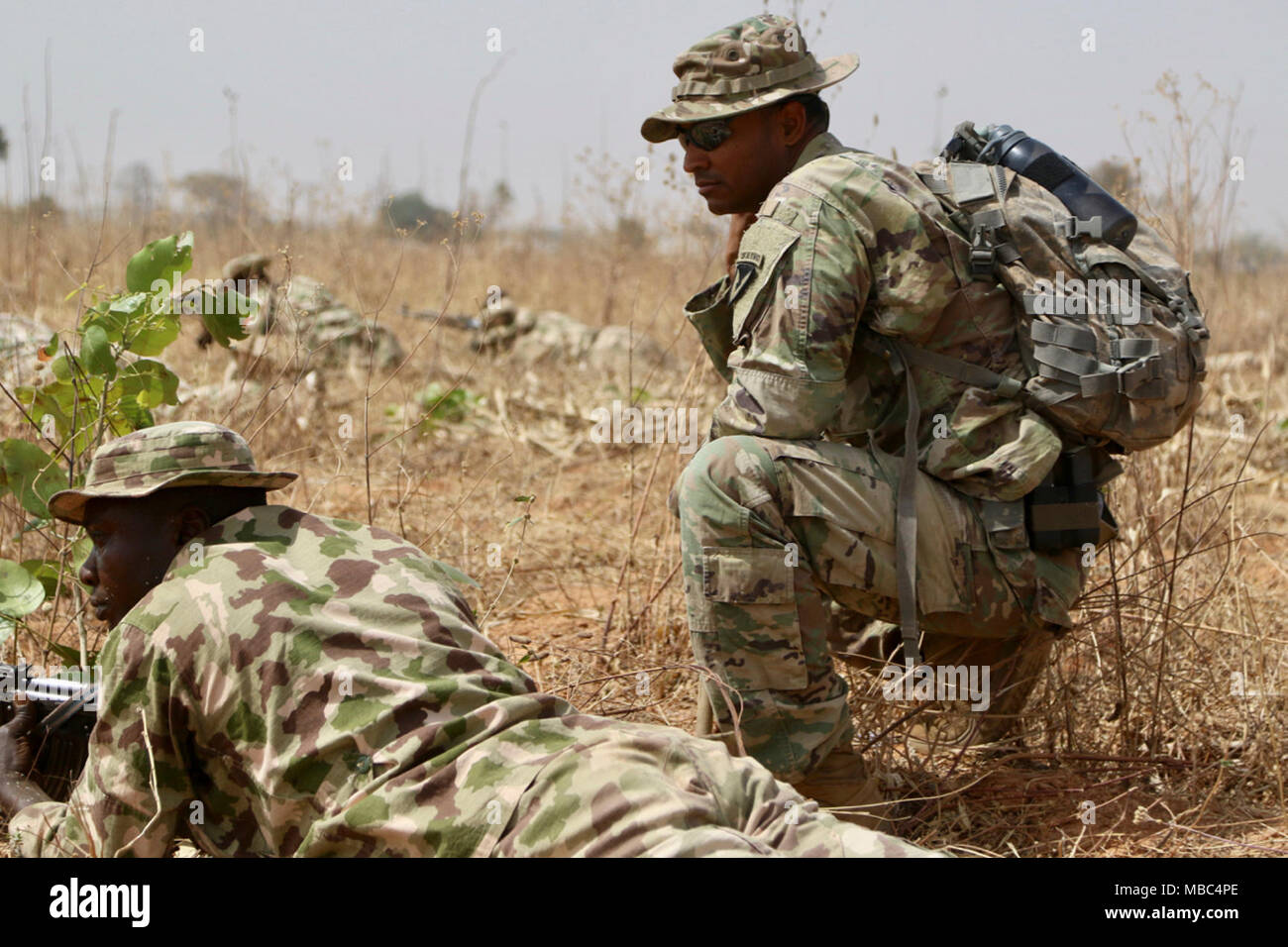 Twelve U.S. Army Soldiers share tactics and training with a little over 200 Nigerian Army Soldiers from 26th Infantry Battalion in a remote military compound four hours north of the capital in Jaji.  The seven- week training includes reacting to an IED, react to an ambush, securing an objective, operations planning, etc.  The training's significance cannot be underestimated.  These Nigerian Soldiers may eventually use these tactics when forward-deployed to fight against the violent terrorist organization, Boko Haram.    Nigerian Advanced infantry training has significant implications outside o Stock Photo