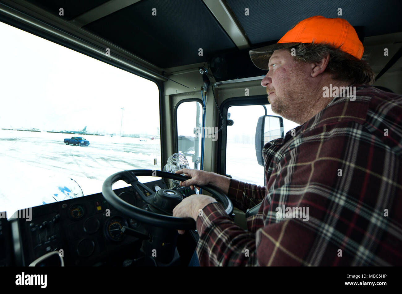 Doug Flint, 92nd Civil Engineer Squadron snow plow operator, clears the flight line using a snow removal truck at Fairchild Air Force Base, Washington, Feb. 14, 2018. Team Fairchild’s Snow Barn is not only responsible for snow and ice control across the flight line, all aircraft parking areas and taxiways, but also all the base streets and parking areas. (U.S. Air Force photo/Senior Airman Janelle Patiño) Stock Photo