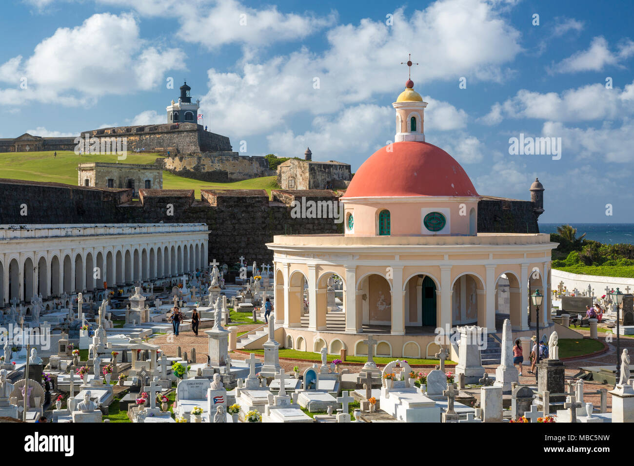 El Morro Fort stands guard over historic Santa Maria Magdalena de Pazzis Cemetery in old San Juan Puerto Rico Stock Photo